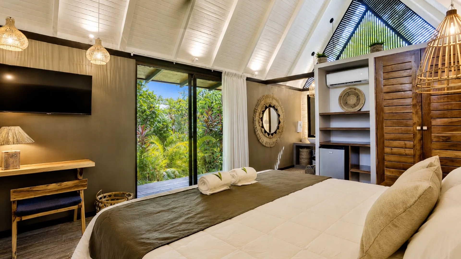 Bungalow bed and glass doors leading to the private deck