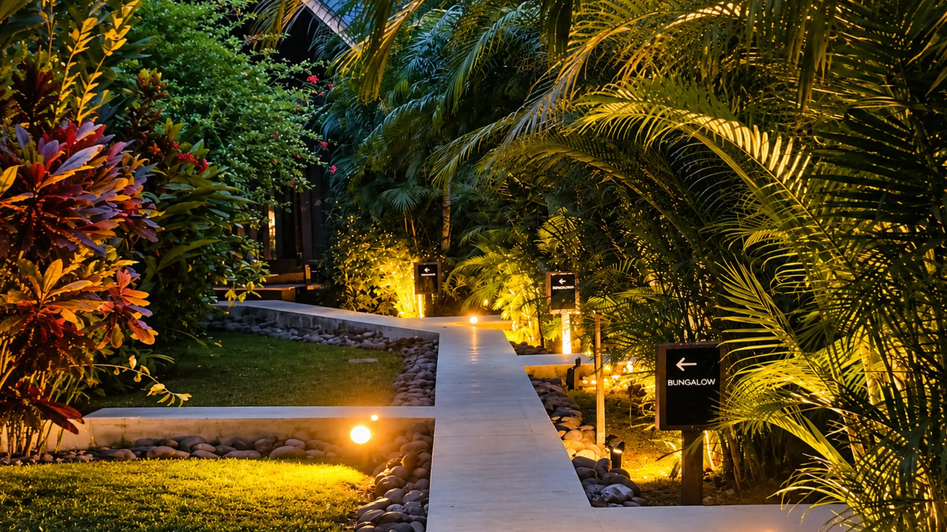 Illuminated path to the bungalows at night