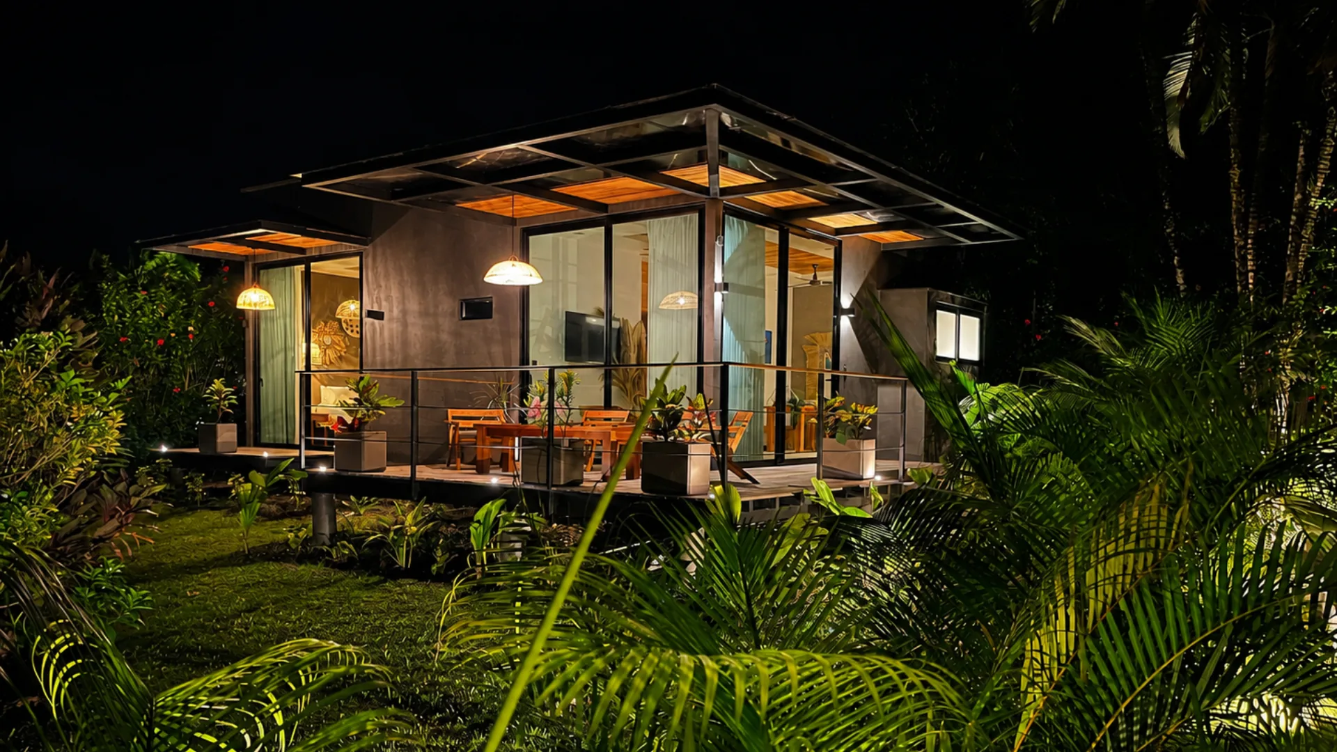Casa Namú exterior at night within the tropical garden