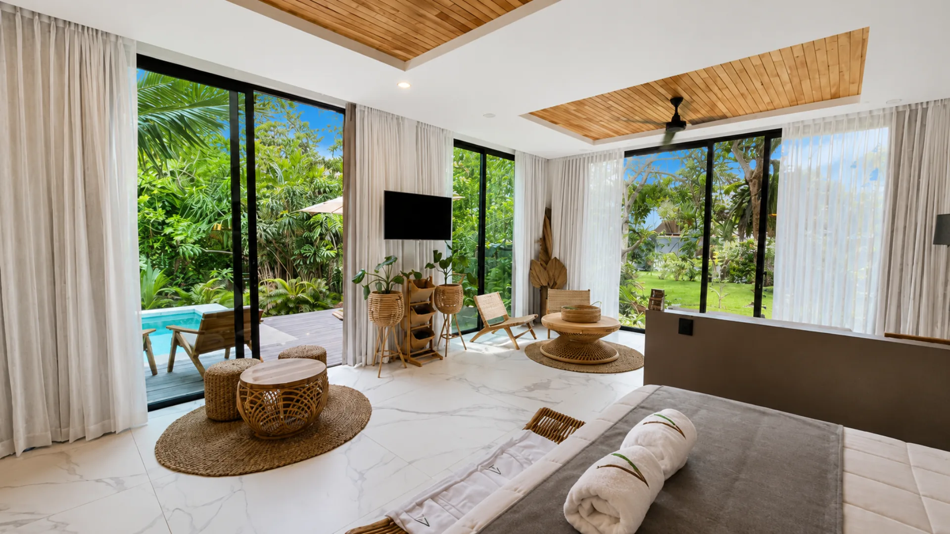 Spacious Luxury Suite interior with garden windows and access to the private pool