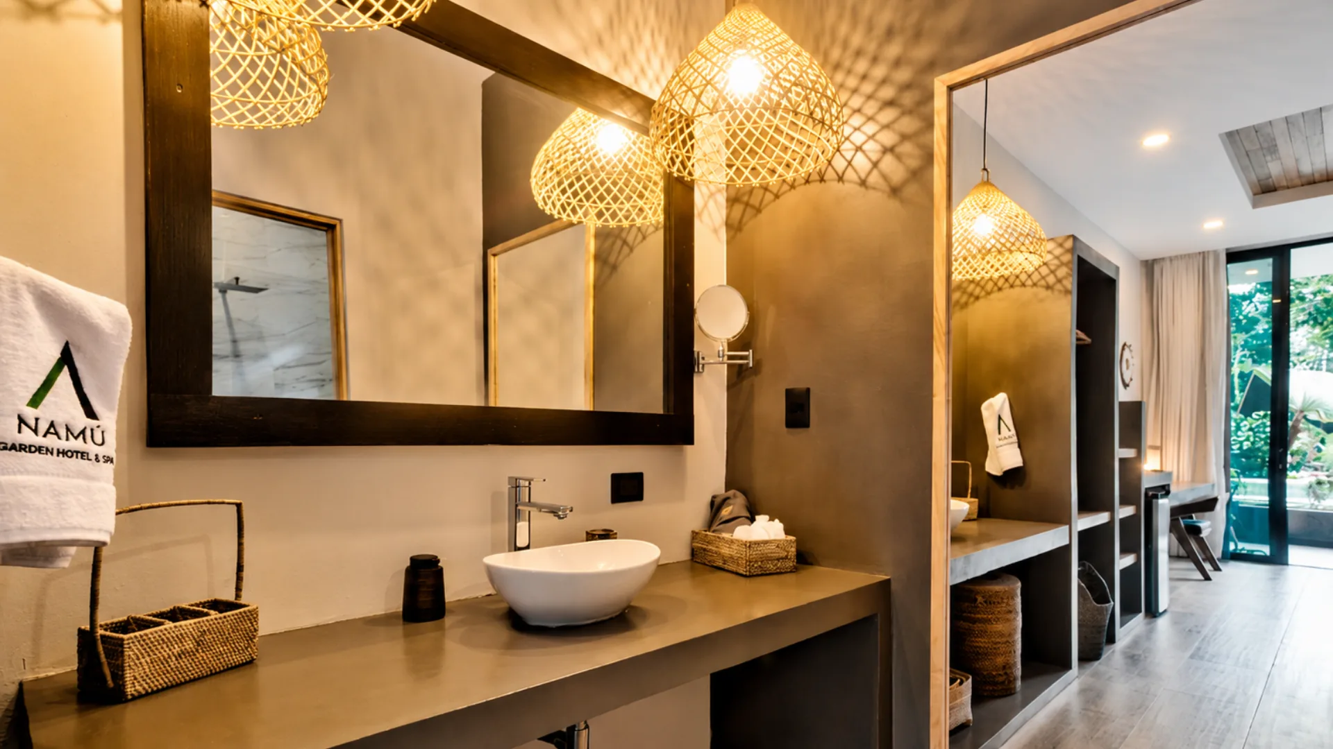 Master Room bathroom with a large mirror and woven lights